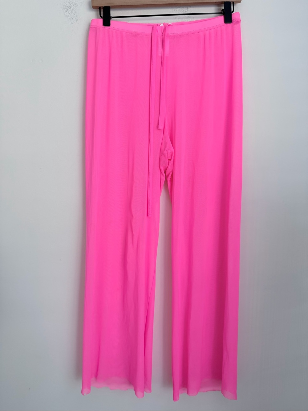 Good American pink sheer wide leg pants raw bottom hem